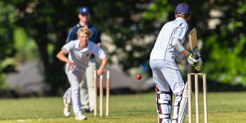 Cricket game teenagers schools game batsman bowler action photo.